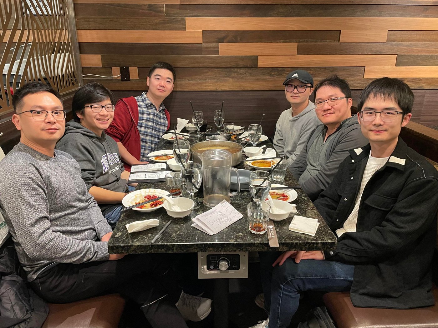 Six men around a hot pot table