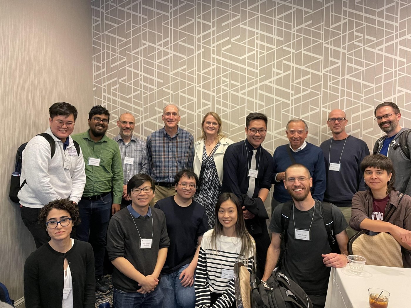 Fifteen conference attendees with name badges; Michael front row, second from left